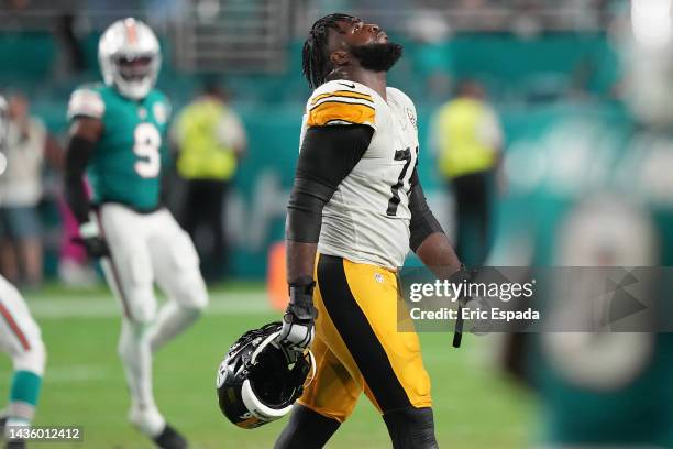 Chukwuma Okorafor of the Pittsburgh Steelers reacts as Noah Igbinoghene of the Miami Dolphins celebrates after making an interception during the...