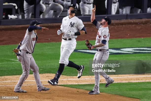 Ryan Pressly and Yuli Gurriel of the Houston Astros celebrate the out of Aaron Judge of the New York Yankees to win game four and the American League...