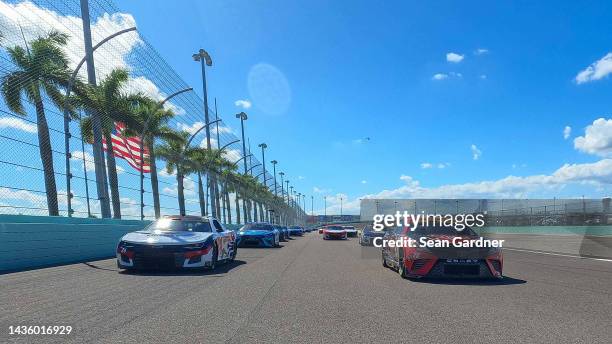 William Byron, driver of the Liberty University Chevrolet, and Christopher Bell, driver of the Rheem - WATTS Toyota, lead the field on a pace lap...