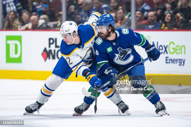 Jack Quinn of the Buffalo Sabres and Conor Garland of the Vancouver Canucks battle for the position in the first period of their NHL game at Rogers...