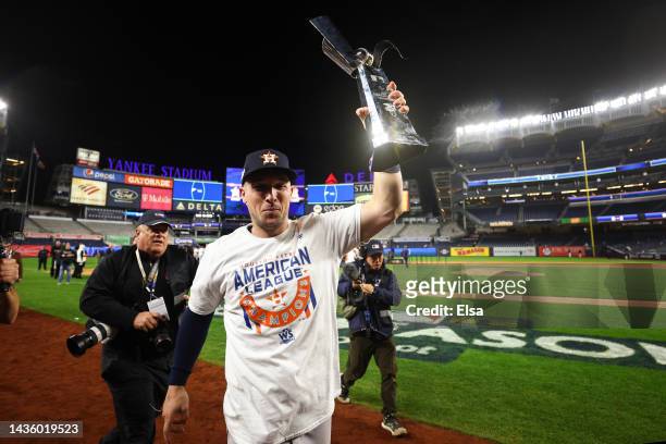Alex Bregman of the Houston Astros celebrates with the American League Championship Series trophy after winning game four against the New York...