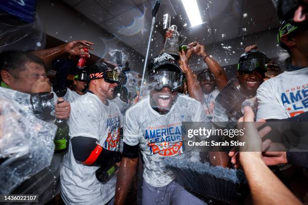 Hector Neris and Christian Vazquez of the Houston Astros celebrate in the locker room after defeating the New York Yankees in game four of the...