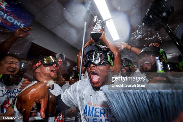 Hector Neris and Christian Vazquez of the Houston Astros celebrate in the locker room after defeating the New York Yankees in game four of the...