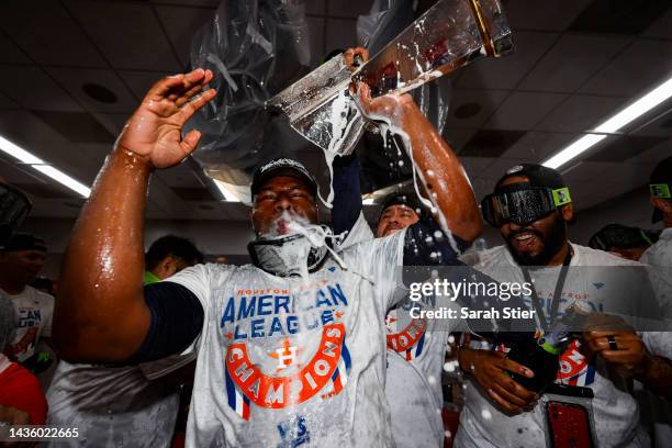 Hector Neris of the Houston Astros celebrates in the locker room after defeating the New York Yankees in game four of the American League...