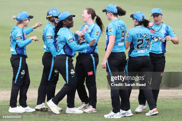 Amanda-Jade Wellington of the Adelaide Strikers celebrates with team mates after bowling Erica Kershaw of the Melbourne Renegades for 3 runs during...