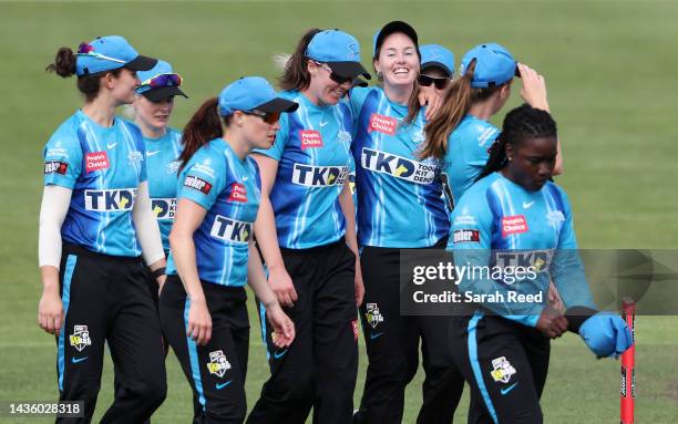 Amanda-Jade Wellington of the Adelaide Strikers surrounded by team mates as they walk off after getting the Renegades all out for 101 runs during the...