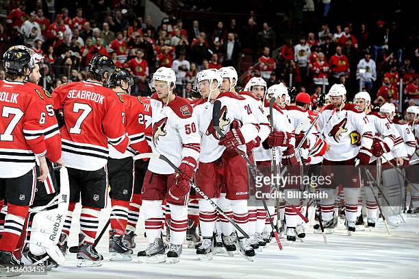The Chicago Blackhawks and the Phoenix Coyotes shake hands after the Coyotes won the Western Conference Quarterfinals against the Blackhawks during...