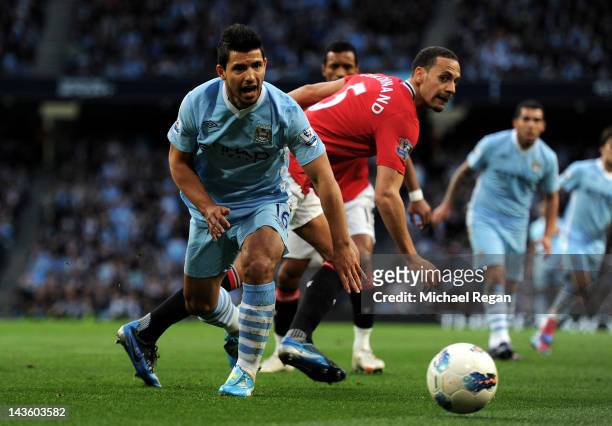 Rio Ferdinand of Manchester United tangles with Sergio Aguero of Manchester City during the Barclays Premier League match between Manchester City and...