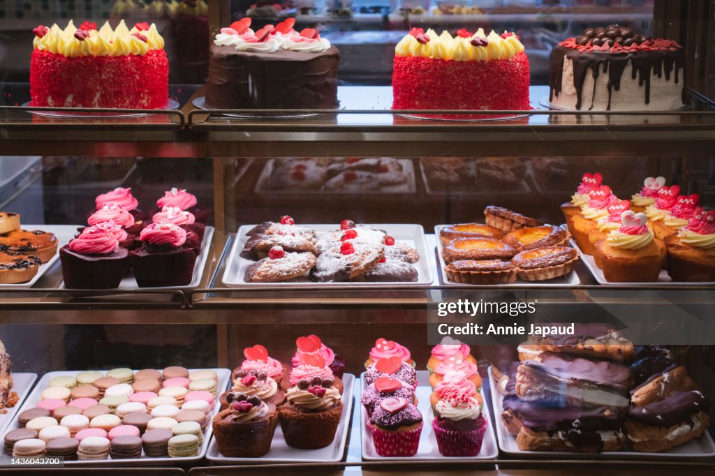 Front View Of Bakery Display Cabinet With Selection Of Delicious Cakes front-view-of-bakery-display-cabinet-with-selection-of-delicious-cakes