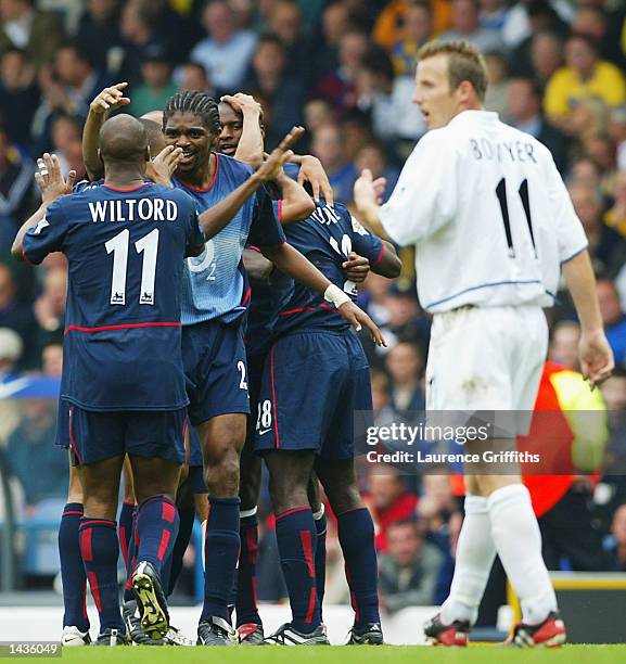 Kanu and Sylvain Wiltord of Arsenal celebrate as Lee Bowyer looks on during the FA Barclaycard Premiership match between Leeds United and Arsenal at...