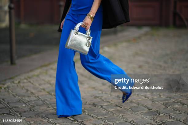 Alba Garavito Torre wears a black blazer jacket, a royal blue sleeveless / suit tank-top from Zara, matching royal blue flared suit pants, gold...