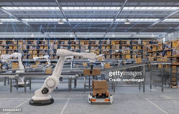 distribution warehouse with plexus, automated guided vehicles and robots working on conveyor belt - conveyer belt stockfoto's en -beelden