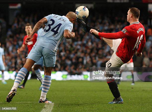 Wayne Rooney of Manchester United clashes with Nigel de Jong of Manchester City during the Barclays Premier League match between Manchester City and...