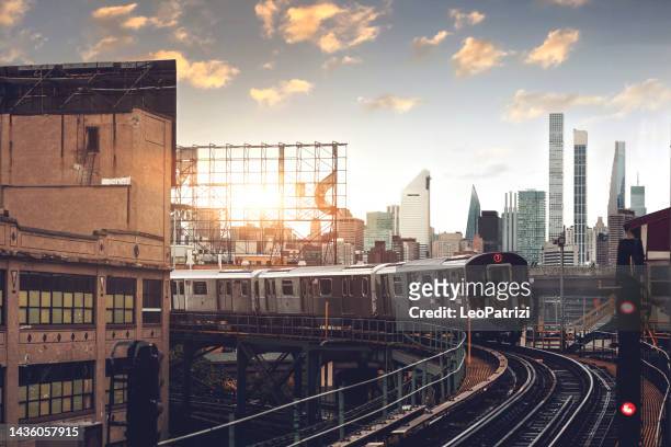 new york city subway train overground in the queens - queens - new york city stock pictures, royalty-free photos & images