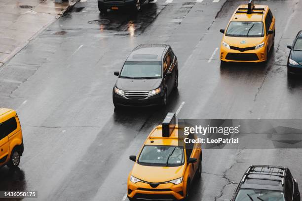 yellow taxi cabs and cars in new york traffic - yellow taxi stock pictures, royalty-free photos & images