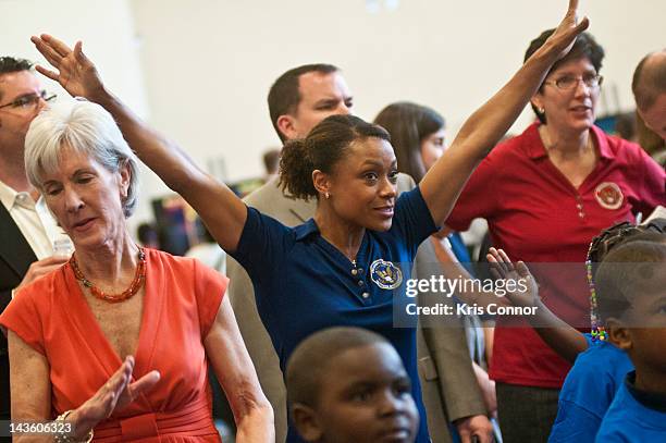 Kathleen Sebelius and Dominique Dawes participate with children duing the Active Play Video Game Demonstration at Walker-Jones Education Campus on...