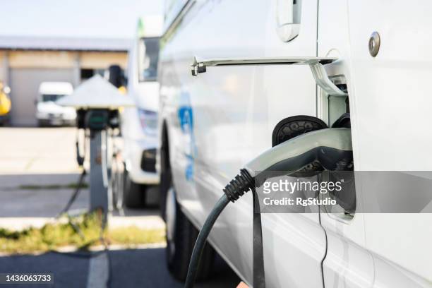 charging the electric van - electrical component imagens e fotografias de stock