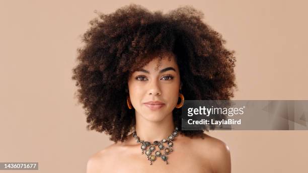 black woman afro, portrait and confident face in beauty and style against a studio background. beautiful isolated african american female proud model with necklace, jewelry and hairstyle for fashion - jewellery model stockfoto's en -beelden