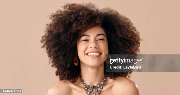 black woman, smile and hair in natural afro for fashion, cosmetics or hair care with neutral studio backdrop. model, happy and makeup in face, jewelry and curly style portrait with brown background - curly brown hair stock pictures, royalty-free photos & images