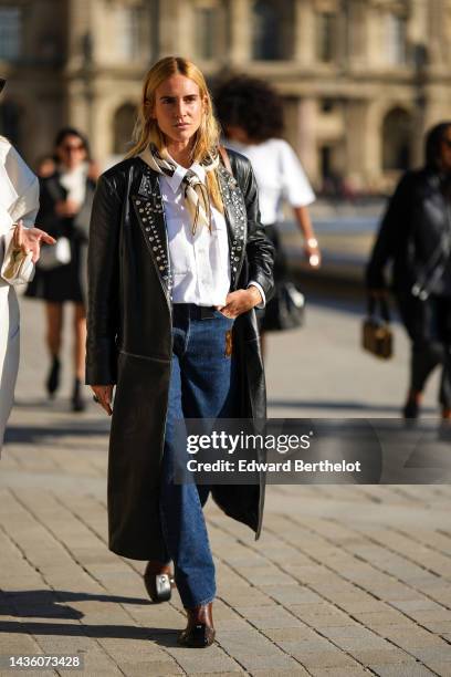 Blanca Miro wears a beige and brown silk print pattern scarf from Louis Vuitton, a white shirt, a black shiny leather nailed / studded collar long...