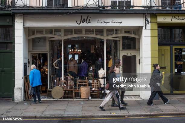 People walk past a vintage clothing shop in Greenwich on October 23, 2022 in London, England.