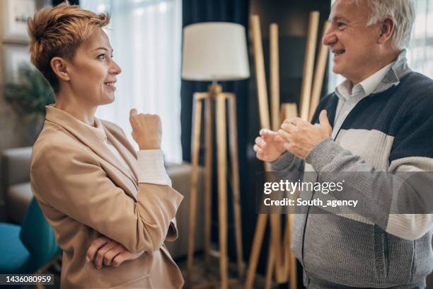 father and daughter successful businessman and businesswoman talking about work - successor 個照片及圖片檔