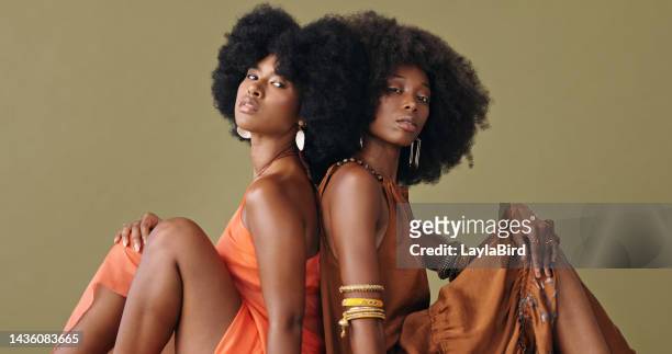 black women, afro hair and fashion clothes on studio background in pride and feminine empowerment. portrait, confident or beauty model friends with style, trend or cool hairstyle and clothing - funky stockfoto's en -beelden