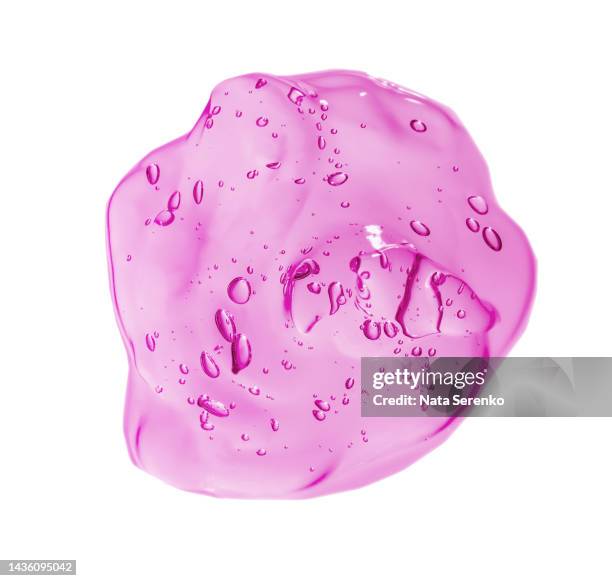 close up macro aloe vera gel serum cosmetic texture pink with bubbles isolated on white background. - aloe vera gel stock-fotos und bilder