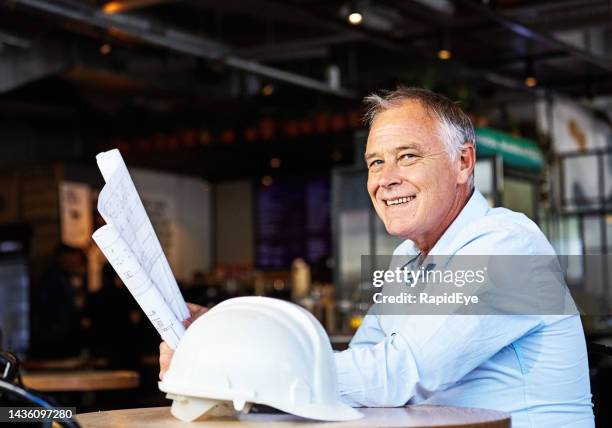 architect, engineer or construction boss with plans and hard hat - restaurant building drawing stock pictures, royalty-free photos & images