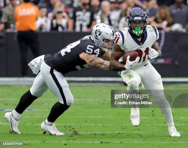 Running back Dameon Pierce of the Houston Texans avoids a tackle by linebacker Blake Martinez of the Las Vegas Raiders on an 11-yard pass play in the...