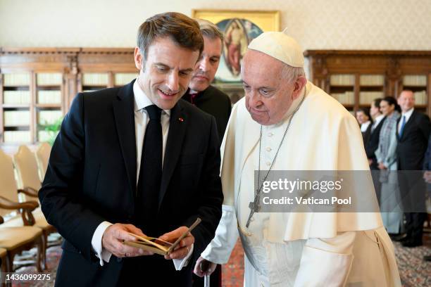 Pope Francis exchanges gifts with President of France Emmanuel Macron at the Apostolic Palace on October 24, 2022 in Vatican City, Vatican.