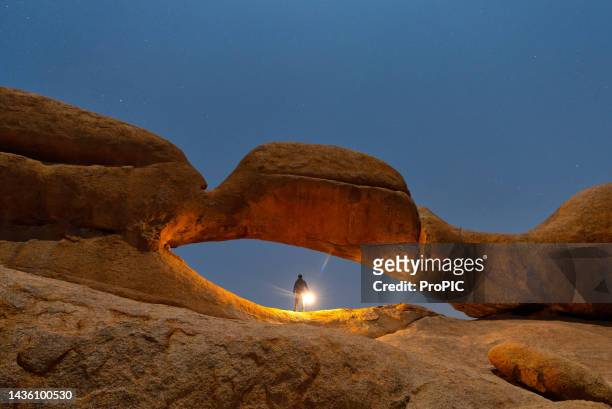 spitzkoppe nature reserve in namibia, gorgeous stone arches painted with iron oxide in red-orange at night - namibia sternenhimmel stock-fotos und bilder