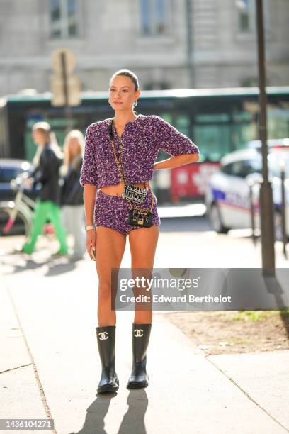 Guest wears multicolored pearls earrings, a purple and pale pink braided wool short sleeves / buttoned jacket, matching purple and pale pink braided...