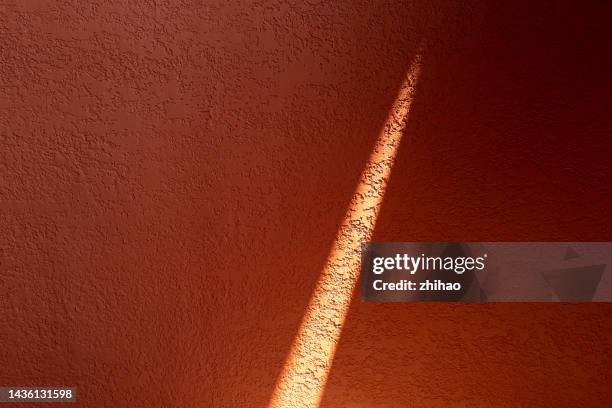 light effect on red concrete wall - manufactured object stock pictures, royalty-free photos & images