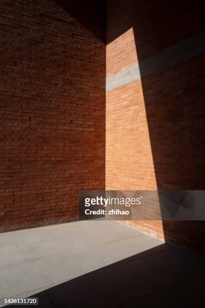 light illuminates part of the brick house - trapezoid stock pictures, royalty-free photos & images