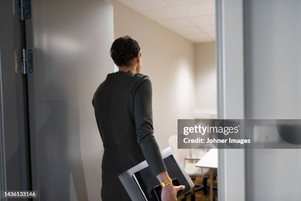 businesswoman entering boardroom - entering ストックフォトと画像