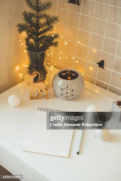 open notebook notepad for writing plans or goals for new year. home christmas festive decor on white table. mockup concept - goede voornemens stockfoto's en -beelden