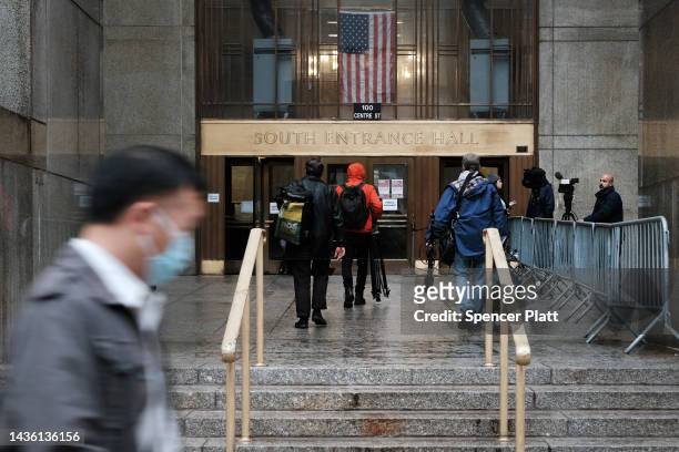 People walk by New York State Supreme Court building during the start of jury selection in a case against the Trump Organization following a year...