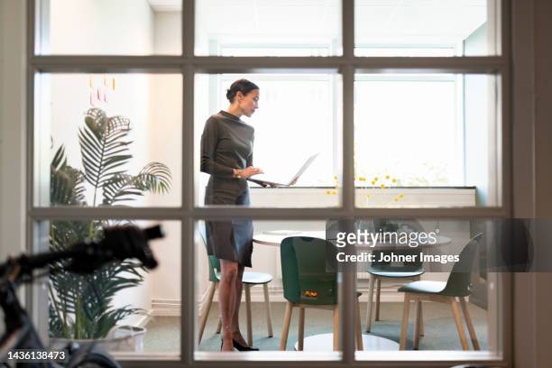 woman working in office - woman table standing stock pictures, royalty-free photos & images