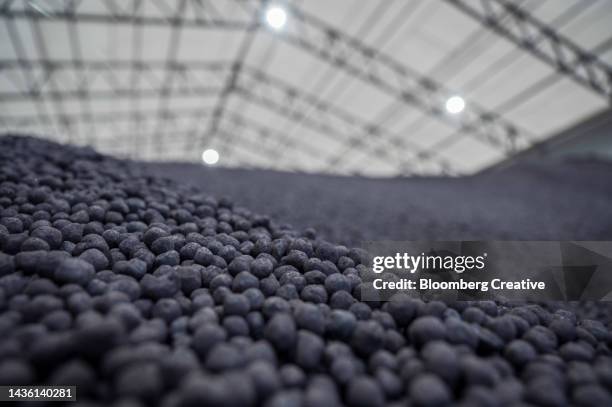 a heap of iron pellets - metal ore stock pictures, royalty-free photos & images