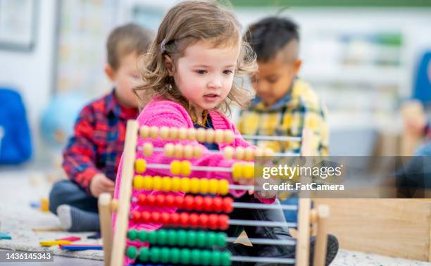 preschool child playing with an abacus - preschool student stock pictures, royalty-free photos & images