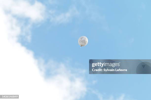 Balloon with Lola written on is seen in the sky above the collegiate church "St Omer" after the funeral of Lola on October 24, 2022 in Lillers,...