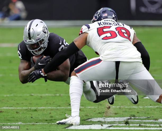 Running back Josh Jacobs of the Las Vegas Raiders is tackled by linebacker Christian Kirksey of the Houston Texans in the first half of their game at...