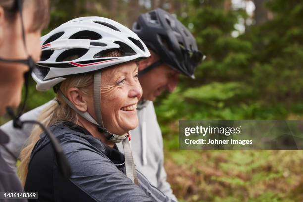 people in bicycle helmets in forest - cycling helmet stock pictures, royalty-free photos & images
