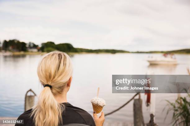 woman having ice-cream at lake - glasstrut bildbanksfoton och bilder
