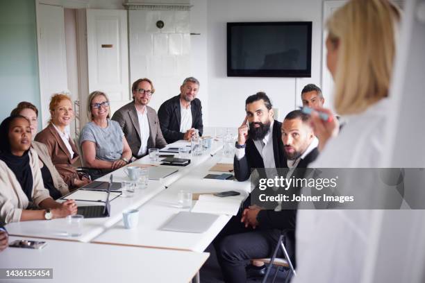 woman having presentation at business meeting - 40 50 business woman stock pictures, royalty-free photos & images