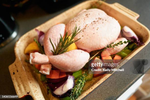 home cooking raw chicken with vegetables sunday roast dinner - stuffing stock pictures, royalty-free photos & images
