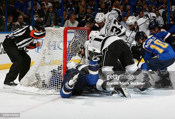 The Los Angeles Kings and the St. Louis Blues scramble for a loose puck near the goal line in Game Two of the Western Conference Semifinals during...