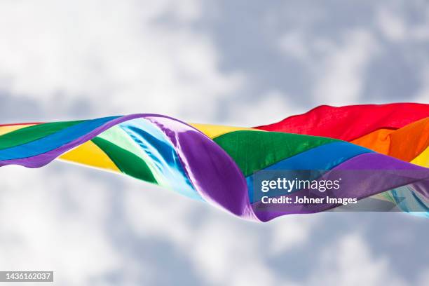 rainbow flag in wind - regenbogenfahne stock-fotos und bilder