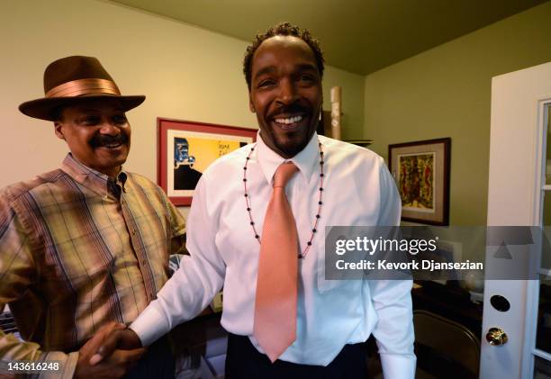 Rodney King is greeted by Firpo Carr as he arrives at EsoWon bookstore to sign copies of his new book, "The Riot Within: My Journey From Rebellion to...